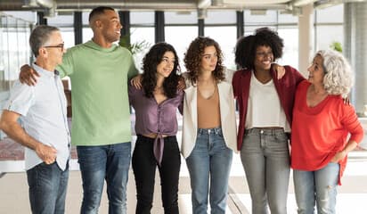 Consultant working at a desk with multiple screens